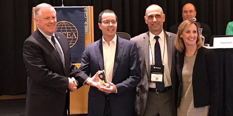 From l-r, Lt. Gen. Robert Shea, USMC (Ret.), president and CEO of AFCEA International, presents the winner’s trophy to Mike Fong, CEO of Privoro, after his company’s technology was chosen as the top competitor in the championship round of AFCEA International’s small business innovative shark tank. Also present are John Kreger of MITRE, chairman of the AFCEA Homeland Security Committee and Tina Jordan, AFCEA vice president of membership.