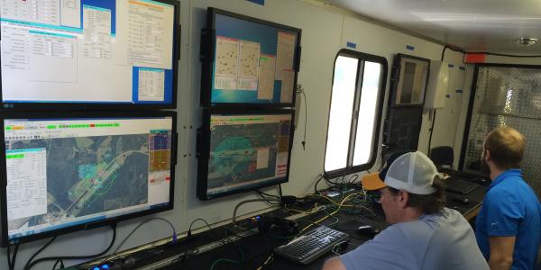 An unmanned aerial vehicle (UAV) pilot sits at the controls during flight tests evaluating cybersecurity. New approaches are being studied to ensure cybersecurity for links to and systems onboard UAVs.