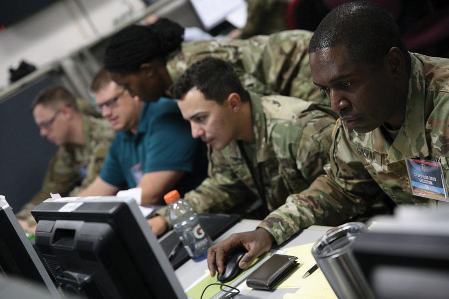 U.S. service members and civilians, along with partner nation service members, work to improve tactical-level cyber operations skills against a live opposing force at the Joint Training Facility in Suffolk, Virginia, during a U.S. Cyber Command annual exercise.