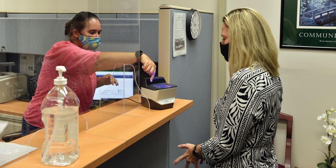 Leslie Bryant, civilian personnel office staffing chief, demonstrates how to give fingerprints to Jayme Alexander, Airmen and Family Readiness Center casualty assistance representative selectee. Although requiring fingerprints to access information is better than single-factor identification verification, it should be part of a multifactor authentication approach. Credit: 2nd Lt. Benjamin Aronson, USAF