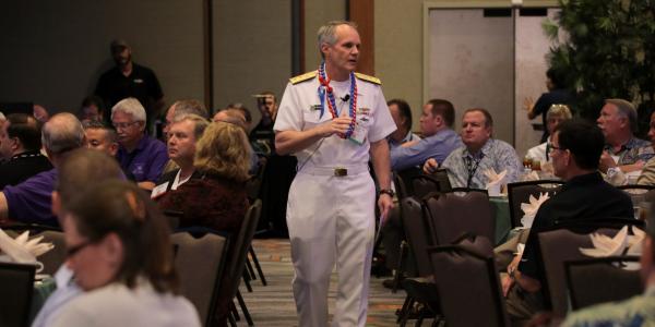 Adm. Phillip G. Sawyer, USN, commander, U.S. Pacific Fleet, walks among the audience as he gives Monday’s keynote luncheon address during TechNet Asia-Pacific 2015.