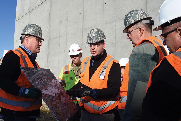 During his tour of the U.S. Strategic Command’s (STRATCOM’s) C2F construction, Gen. John E. Hyten, USAF, (2nd from r), commander, STRATCOM, receives a briefing from members of the command’s Program Management Office, Michael Kolster (2nd from l), military construction chief, and James Weber, operations and strategic communications action officer. The facility is designed to meet current mission requirements with the flexibility to expand for future mission needs. Photo by Master Sgt. April Wickes, USAF