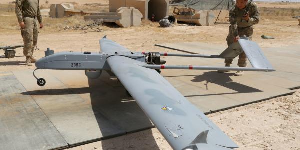 U.S. Army soldiers with Company D, 52nd Brigade Engineer Battalion, 2nd Infantry Brigade Combat Team, 4th Infantry Division, conduct a preflight inspection of an RQ-7B Shadow unmanned aerial system at a base in Iraq.