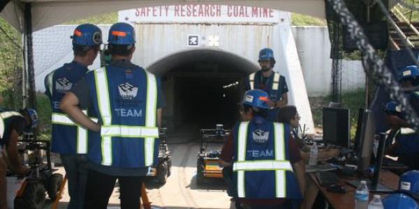 Members of Team Co-STAR from the Jet Propulsion Laboratory, California Institute of Technology, Massachusetts Institute of Technology and South Korea’s KAIST Lab prepare to send their autonomous systems into one of the coal mine tunnels during the Subterranean Challenge.
