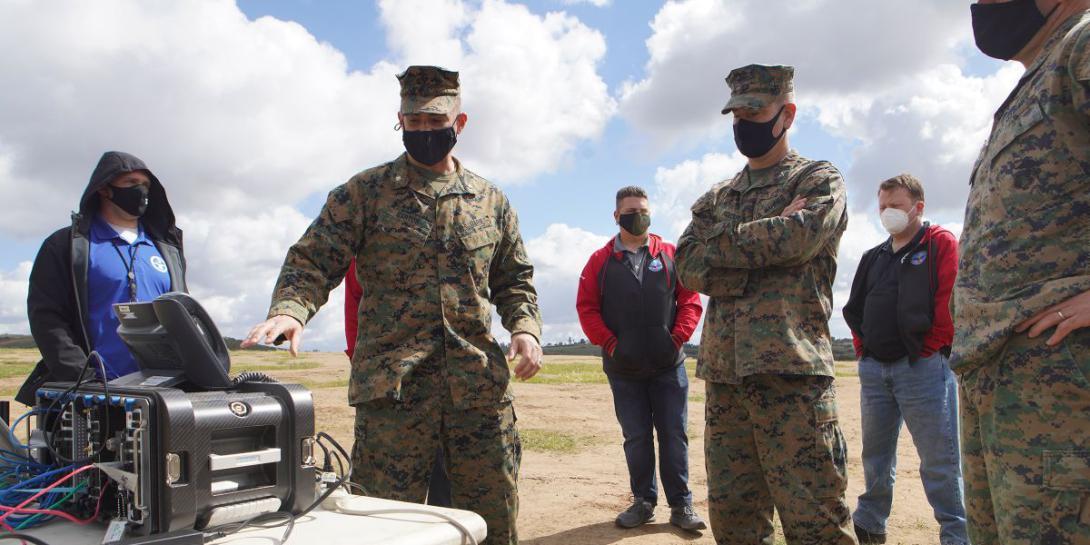 A U.S. Marine Corps lieutenant colonel with the Defense Information Systems Agency (DISA) explains a Cloud Layered Obfuscation Application Kit (CLOAK) to the commanding officer for I Marine Expeditionary Force (I MEF) Information Group. CLOAK uses commercial cloud computing resources to improve I MEF connectivity. U.S. Marine Corps photo