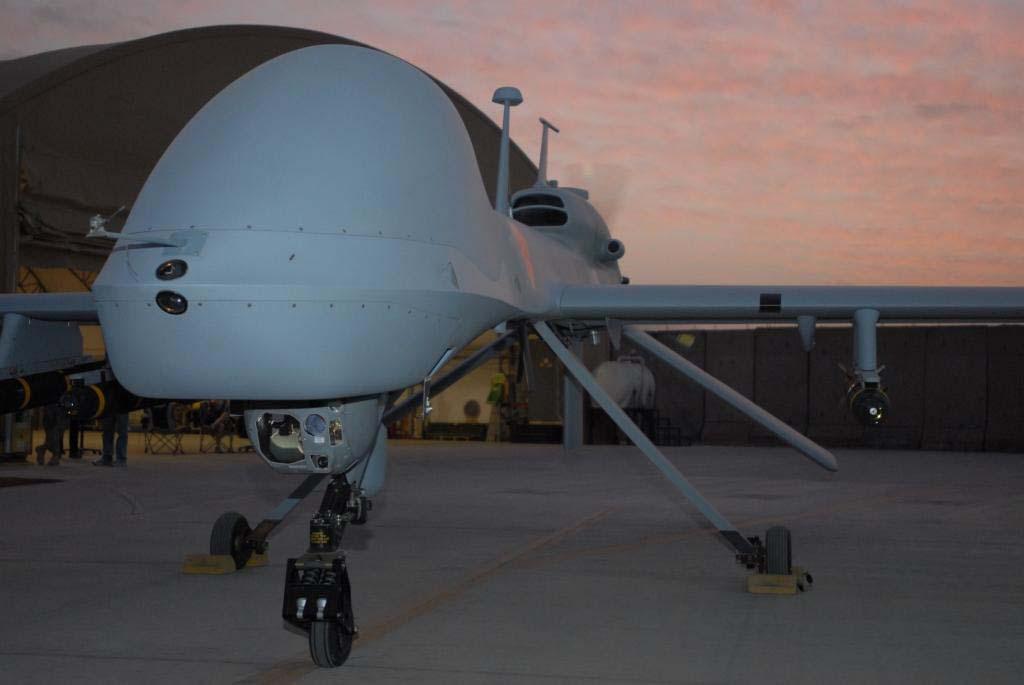 An MQ-1C Gray Eagle armed with Hellfire missiles revs up before taking flight at Camp Taji, Iraq, in 2011.