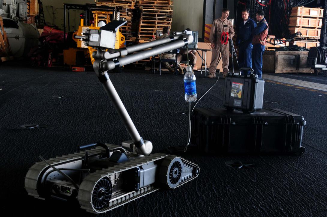 U.S. Navy sailors with Explosive Ordnance Disposal Mobile Unit 11, Platoon 1131, explain how explosive ordnance and demolition personnel use robots to investigate explosives.
