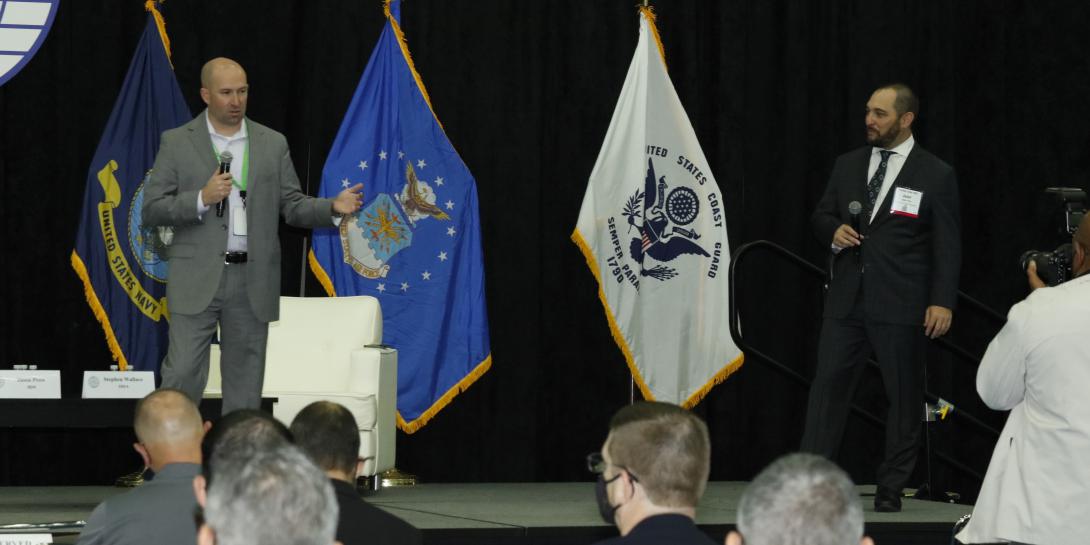 Stephen Wallace, DISA’s chief technology officer and director of the agency’s Emerging Technologies Directorate (l), and Jason Prow, partner, U.S. federal intelligence connected operations and automation leader, IBM, speak at TechNet Cyber in Baltimore. Photo by Michael Carpenter