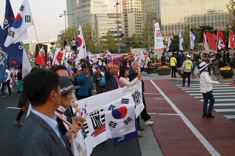 Influence operations in the invisible world of cyberspace have real-world consequences. After South Koreans heard about the disinformation campaign that helped elect Park Geun-hye as the republic’s president, they took to the streets to protest against the government. Credit: Steve Edreff/Shutterstock.com