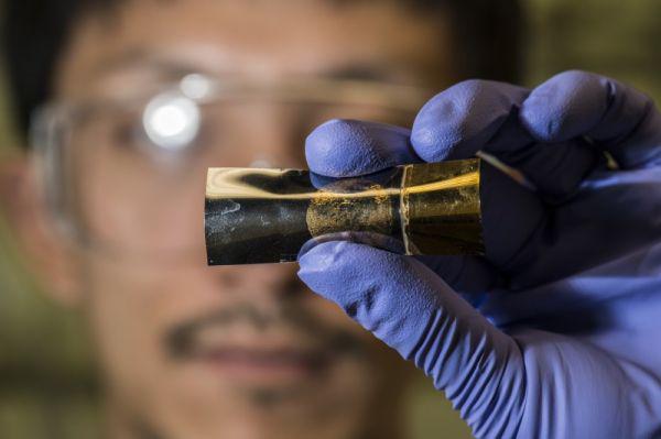Rice University postdoctoral researcher Yang Yang holds an energy storage unit with the best qualities of batteries and supercapacitors in a scalable, flexible package.