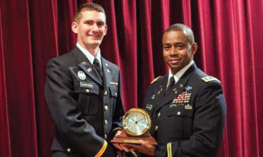 Cadet Joel Whitehead (l) receives the AFCEA Army ROTC Clock from Lt. Col. Jackie McDowell, USA, professor of military science, Middle Tennessee State University.