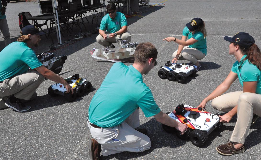 Sly Fox Mission 23 team, Naval Surface Warfare Center Dahlgren Division, demonstrates Autonomous Remote Tactical Engagement Multi-Domain Intelligence Swarm (ARTEMIS). The team used artificial intelligence and machine learning to develop unmanned vehicle swarms that can counteract potential threats of swarming unmanned systems. Photo by John Joyce