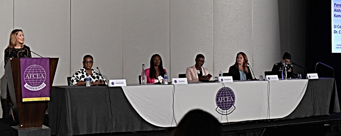 Tina Jordan, vice president of Membership for AFCEA International, introduces speakers for the “Girls and Women in STEM: How Do We Get the Girls’ Attention?” panel, moderated by Essye Miller, retired DoD principal deputy chief information officer, seated far left. Panelists, from l to r, included Aisha Bowe; Kameke Mitchell; Christine Anne Royce; and Lt. Col. Julianna Rodriguez, USA. Photo by Elizabeth Moon