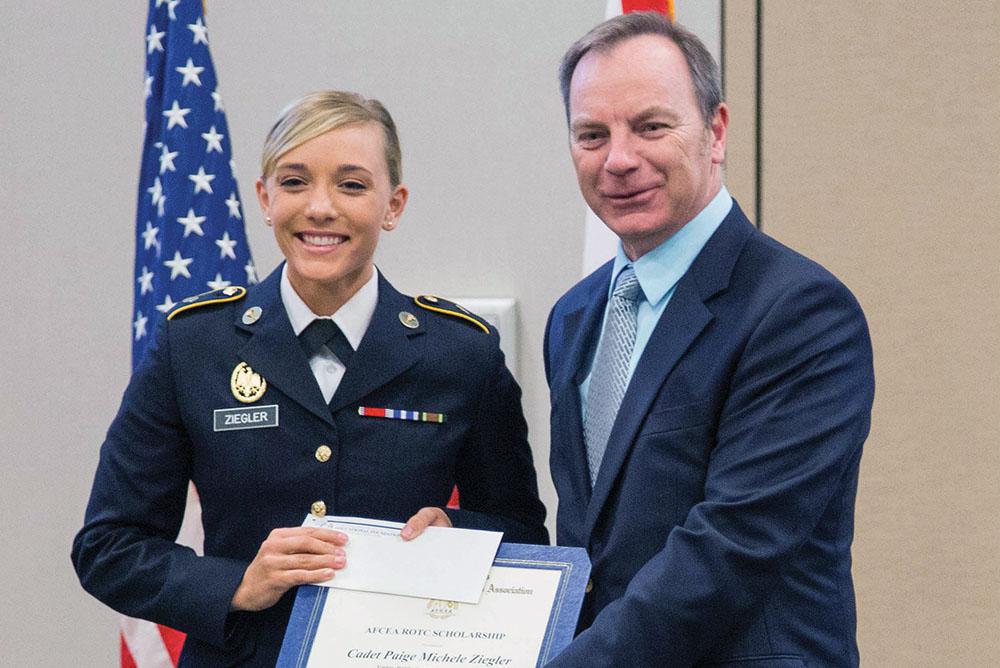 Cadet Paige Michele Ziegler (l), Embry-Riddle Aeronautical University, receives an AFCEA ROTC scholarship from Jason Irving, vice president of scholarships for AFCEA’s Orlando-Central Florida Chapter. The foundation’s ROTC scholarships, ranging from $2,000 to $3,000 each, go to full-time students in a C4I-related major.