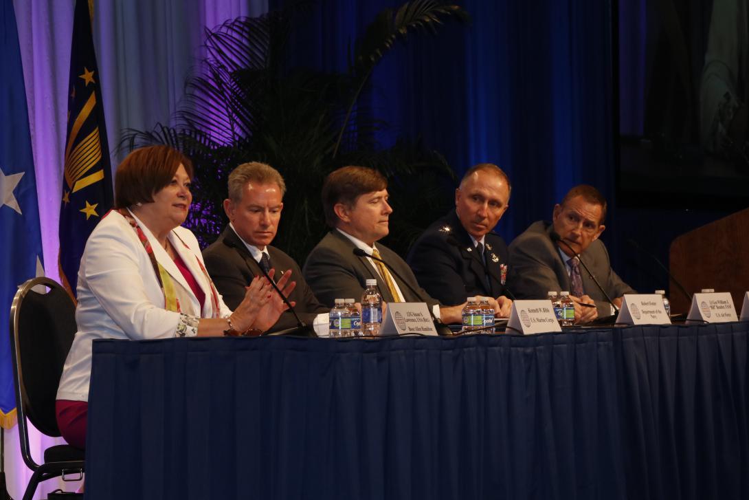 Lt. Gen. Susan Lawrence, USA (Ret.), of Booz Allen Hamilton, former Army CIO (l) compares her time in industry with her military career in a CIO panel with (l-r) Ken Bible, Marine Corps deputy CIO; Robert Foster, Navy CIO; Lt. Gen. William J. Bender, USAF, Air Force CIO; and moderator Lt. Gen. Mike Basla, USAF (Ret.), of CACI.