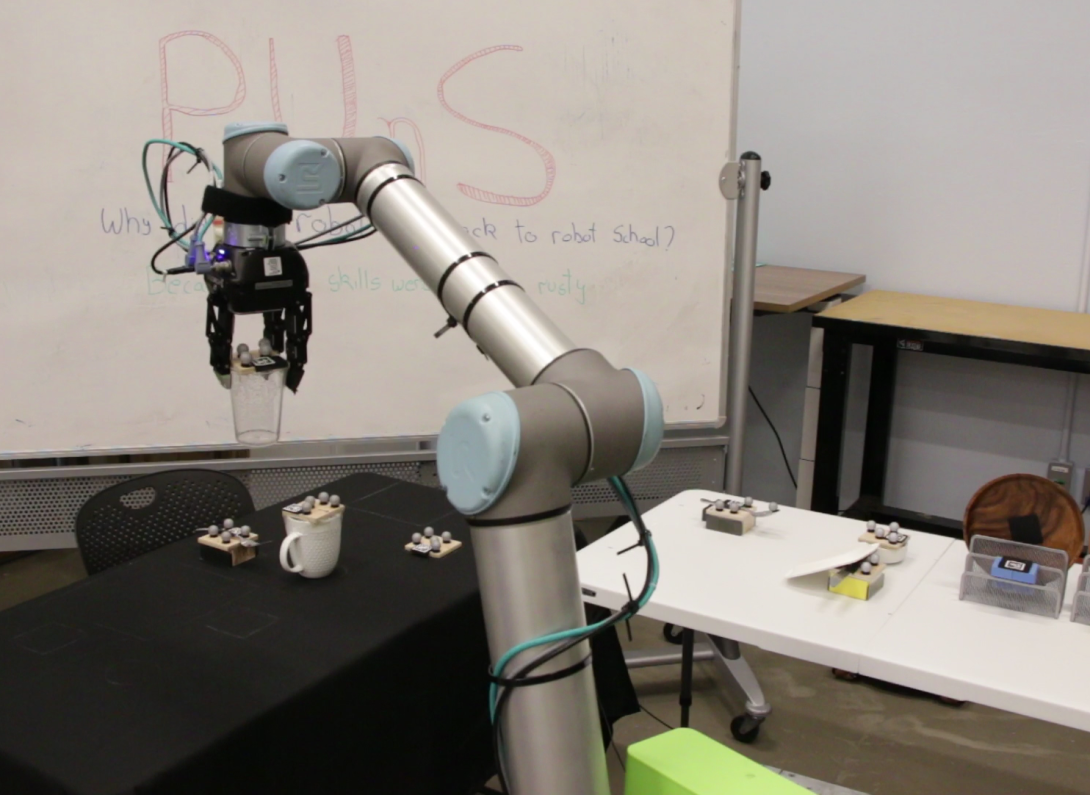 Researchers use markers to aid the robotic arm. The metallic spheres are retro-reflective markers used with the motion capture system, and the scanner codes are fiducial markers that help the system determine the position and orientation of objects.  MIT Interactive Robotics Group