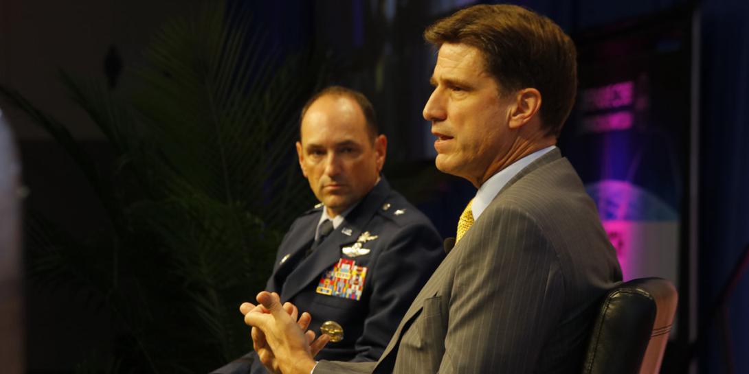 Dana Deasy, the new DOD CIO (r), chats with Brig. Gen. Kevin B. Kennedy, USA, during the Defensive Cyber Operations Symposium.