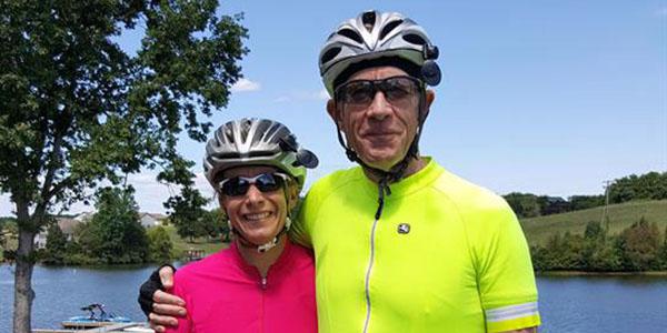 Andrew Loerch (r), an avid cyclist pictured with his wife Claire, contributed greatly to AFCEA NOVA’s George Mason University subchapter. Loerch was an associate chair of the Department of Systems Engineering and Operations Research at George Mason University. Photo courtesy of Pierce Funeral Home/Loerch family.