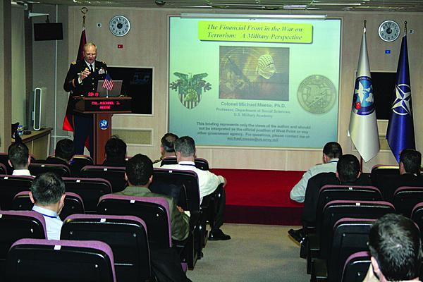 Col. Michael J. Meese, USA, gives a presentation on financial aspects in defense against terrorism. Cutting off the financial chain that supports terrorism is a long-standing effort, but now cyberspace has emerged as a tool for terrorist financial activities.