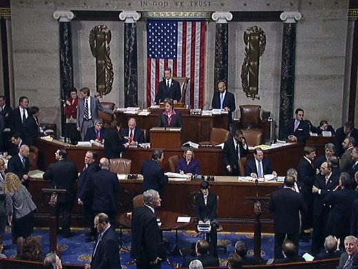 U.S. House of Representative members await on the floor for the final tally of a vote Friday on DHS funding.