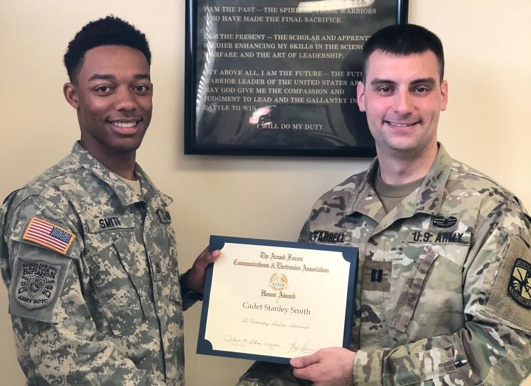 Cadet Stanley Smith, Army ROTC, Florida A&M University (l), receives an AFCEA ROTC Honor Award from Capt. Robert Farrell, USA, assistant professor of military science.