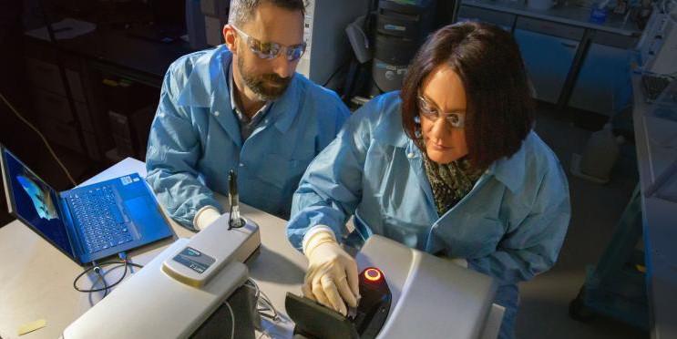 LNL researchers Nick Fischer and Amy Rasley are characterizing nanolipoprotein particle vaccine formulations using a dynamic light-scattering instrument. The researchers are part of a team developing one vaccine to protect U.S. forces against three different bacterial biothreats. Credit: Julie Russell/LLNL