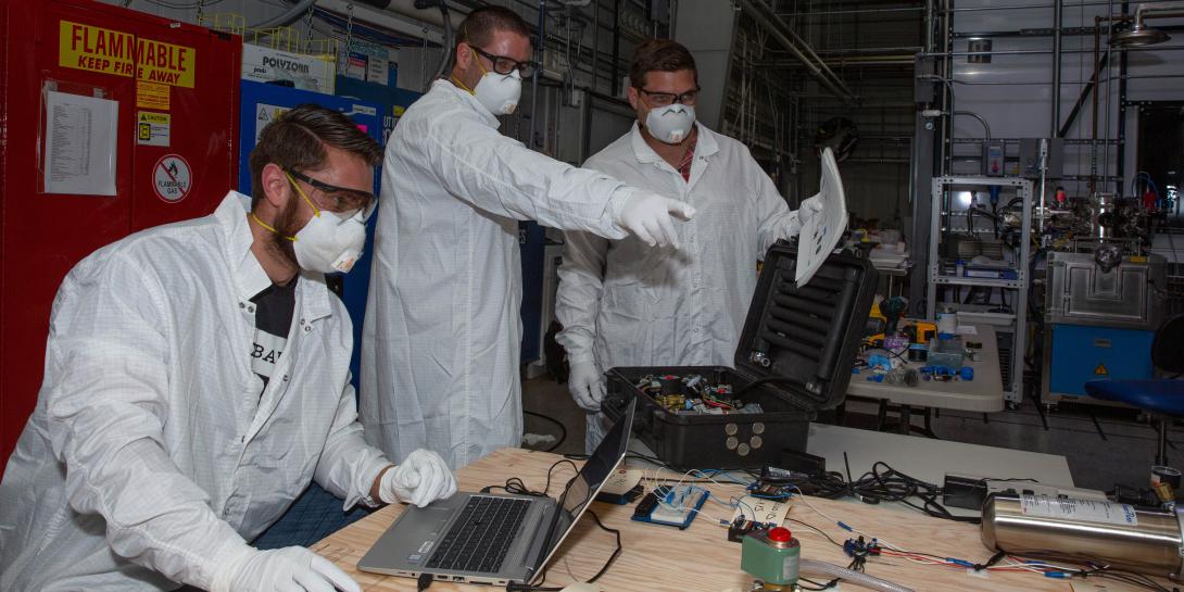 LLNL mechanical engineer Ken Enstrom (l) and technicians Greg Norton (c) and Aaron Sperry test and validate simple ventilator prototypes that could be easily assembled from readily available parts. Photo by Julie Russell/LLNL